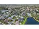 Spacious community featuring tree-lined streets, community pool, and a tranquil lake at 8014 Planters Knoll Ter, Bradenton, FL 34201