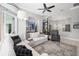 Bright living room featuring a white sectional sofa, neutral rug, and seamless access to the outdoors at 8014 Planters Knoll Ter, Bradenton, FL 34201