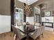 Dining room with an elegant chandelier, large window, and hardwood floors at 8016 Bowspirit Way, Lakewood Ranch, FL 34202