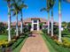 Inviting home exterior with a well-manicured lawn, a brick driveway, and lush tropical landscaping at 8016 Bowspirit Way, Lakewood Ranch, FL 34202