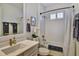 Bathroom featuring a shower over tub, vanity with sink, and decor at 8192 Sternway Rd, Sarasota, FL 34240