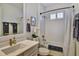 Well-lit bathroom featuring a tub with shower, white vanity and modern fixtures at 8192 Sternway Rd, Sarasota, FL 34240