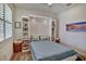 Well-lit bedroom featuring a stylish murphy bed and built-in shelving for optimized storage and a modern look at 8192 Sternway Rd, Sarasota, FL 34240
