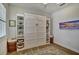 Well-lit bedroom featuring a stylish murphy bed and built-in shelving for optimized storage and a modern look at 8192 Sternway Rd, Sarasota, FL 34240