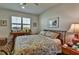 Cozy bedroom with natural light, patterned bedspread and side tables at 8192 Sternway Rd, Sarasota, FL 34240