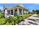 Community clubhouse featuring a welcoming entrance, ramp access, and lush landscaping at 8192 Sternway Rd, Sarasota, FL 34240