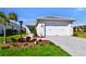 Charming single-Gathering home with a well-manicured lawn and two-car garage showcasing curb appeal at 8192 Sternway Rd, Sarasota, FL 34240