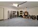 Spacious two-car garage with epoxy flooring and ample storage cabinets at 8192 Sternway Rd, Sarasota, FL 34240