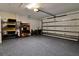 View of epoxy floor, garage door, and organized storage within the spacious three car garage at 8192 Sternway Rd, Sarasota, FL 34240