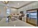 Bright kitchen featuring white cabinetry, stainless steel appliances, an island with seating, and stylish backsplash at 8192 Sternway Rd, Sarasota, FL 34240