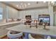 Bright kitchen featuring white cabinetry, stainless steel appliances, an island with seating, and stylish backsplash at 8192 Sternway Rd, Sarasota, FL 34240