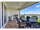 Outdoor patio featuring a built-in grill, comfortable seating, and scenic waterfront views for entertaining guests at 8192 Sternway Rd, Sarasota, FL 34240