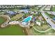 Aerial view of a community pool area with a luxurious pool, clubhouse, and well-manicured landscaping at 8192 Sternway Rd, Sarasota, FL 34240