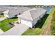 Aerial view of a home with a brick paver driveway, two-car garage and lake view at 8192 Sternway Rd, Sarasota, FL 34240