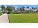 Outdoor area with manicured lawn, pergolas and shady seating around the pool at 8192 Sternway Rd, Sarasota, FL 34240