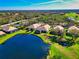 Stunning aerial view of luxurious homes next to a tranquil lake in a beautiful, well-maintained community at 8310 Tartan Fields Cir, Lakewood Ranch, FL 34202