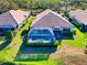 Attractive home with a screened-in pool area, well-manicured lawn, and lush landscaping at 8310 Tartan Fields Cir, Lakewood Ranch, FL 34202