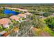 Picturesque aerial shot capturing the serenity of homes nestled alongside a pond, surrounded by lush greenery and landscaping at 8310 Tartan Fields Cir, Lakewood Ranch, FL 34202