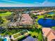 Attractive aerial view featuring homes with pristine landscaping and serene lake views in a well-maintained community at 8310 Tartan Fields Cir, Lakewood Ranch, FL 34202