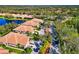 Beautiful aerial view of homes in a landscaped community with pristine streets and lush green spaces alongside a tranquil pond at 8310 Tartan Fields Cir, Lakewood Ranch, FL 34202