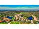 Expansive aerial view of a lush community surrounded by golf course and lakes at 8310 Tartan Fields Cir, Lakewood Ranch, FL 34202