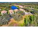Charming aerial perspective of homes in a lakeside neighborhood, highlighted by mature trees and well-kept lawns at 8310 Tartan Fields Cir, Lakewood Ranch, FL 34202