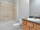 This bathroom features tiled walls and floors, a shower-tub combo, and a single sink vanity at 8310 Tartan Fields Cir, Lakewood Ranch, FL 34202