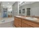 Bathroom with double sink vanity, bathtub, and tile floor at 8310 Tartan Fields Cir, Lakewood Ranch, FL 34202