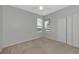 Carpeted bedroom with ceiling fan and closet at 8310 Tartan Fields Cir, Lakewood Ranch, FL 34202