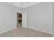 Carpeted bedroom with an open door at 8310 Tartan Fields Cir, Lakewood Ranch, FL 34202