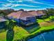 Aerial view of rear of home showing screened lanai and beautiful backyard at 8310 Tartan Fields Cir, Lakewood Ranch, FL 34202