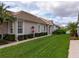 Beautifully landscaped home featuring a lush lawn with an irrigation system at 8310 Tartan Fields Cir, Lakewood Ranch, FL 34202