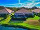 Stunning rear view showcasing the screened lanai and meticulously maintained backyard at 8310 Tartan Fields Cir, Lakewood Ranch, FL 34202