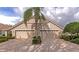 Well-maintained exterior featuring a two-car garage, manicured landscaping, and a neatly paved driveway at 8310 Tartan Fields Cir, Lakewood Ranch, FL 34202