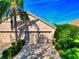 Beige home featuring a lush front yard and spacious three-car garage under a blue sky at 8310 Tartan Fields Cir, Lakewood Ranch, FL 34202