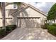 Two car garage featuring carriage doors and is attached to the lovely home at 8310 Tartan Fields Cir, Lakewood Ranch, FL 34202