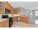 Kitchen featuring wood cabinets, modern appliances, and a spacious layout at 8310 Tartan Fields Cir, Lakewood Ranch, FL 34202