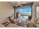 Relax in this covered lanai with comfortable seating and a view of the screened pool and lake at 8310 Tartan Fields Cir, Lakewood Ranch, FL 34202
