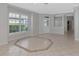 Bright and airy living room featuring tile floors, decorative columns, and big windows at 8310 Tartan Fields Cir, Lakewood Ranch, FL 34202