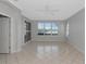 Well-lit living room featuring tile flooring and window shutters at 8310 Tartan Fields Cir, Lakewood Ranch, FL 34202