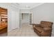 The bright office features an open doorway, built in shelves and an accent chair at 8310 Tartan Fields Cir, Lakewood Ranch, FL 34202