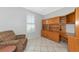 The office boasts large built-in wooden cabinets and drawers, with a cozy chair in the corner at 8310 Tartan Fields Cir, Lakewood Ranch, FL 34202