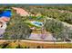 Aerial view of community pool area surrounded by lush landscaping and palm trees at 8310 Tartan Fields Cir, Lakewood Ranch, FL 34202