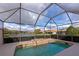 A luxurious, screened in pool and spa with views of the surrounding lake and community at 8310 Tartan Fields Cir, Lakewood Ranch, FL 34202
