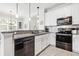 Well-lit kitchen boasts granite countertops, a stainless steel dishwasher and range, and white cabinetry at 8947 Tuscany Isles Dr, Punta Gorda, FL 33950