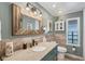 Inviting bathroom featuring a granite countertop, wood accents, and custom vanity lighting at 970 Jolanda Cir, Venice, FL 34285