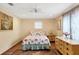 Comfortable bedroom showcasing a cozy bed, a dresser, and windows for natural light at 970 Jolanda Cir, Venice, FL 34285