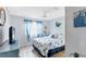 Cozy bedroom featuring natural light, light wood floors, and serene blue and white decor at 970 Jolanda Cir, Venice, FL 34285