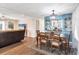 Open-concept dining area with a wooden table, chair set, and adjacent living space at 970 Jolanda Cir, Venice, FL 34285