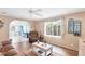 Relaxing living room showcasing a recliner, a wooden coffee table, and scenic views through the window at 970 Jolanda Cir, Venice, FL 34285